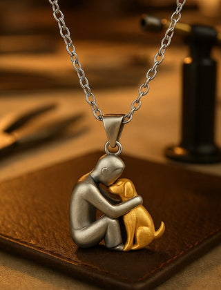 Close view of the dog hug pendant with a gold-tone dog, resting on a workbench