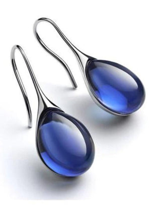 Deep blue teardrop cabochon drop earrings with silver-tone hook wires