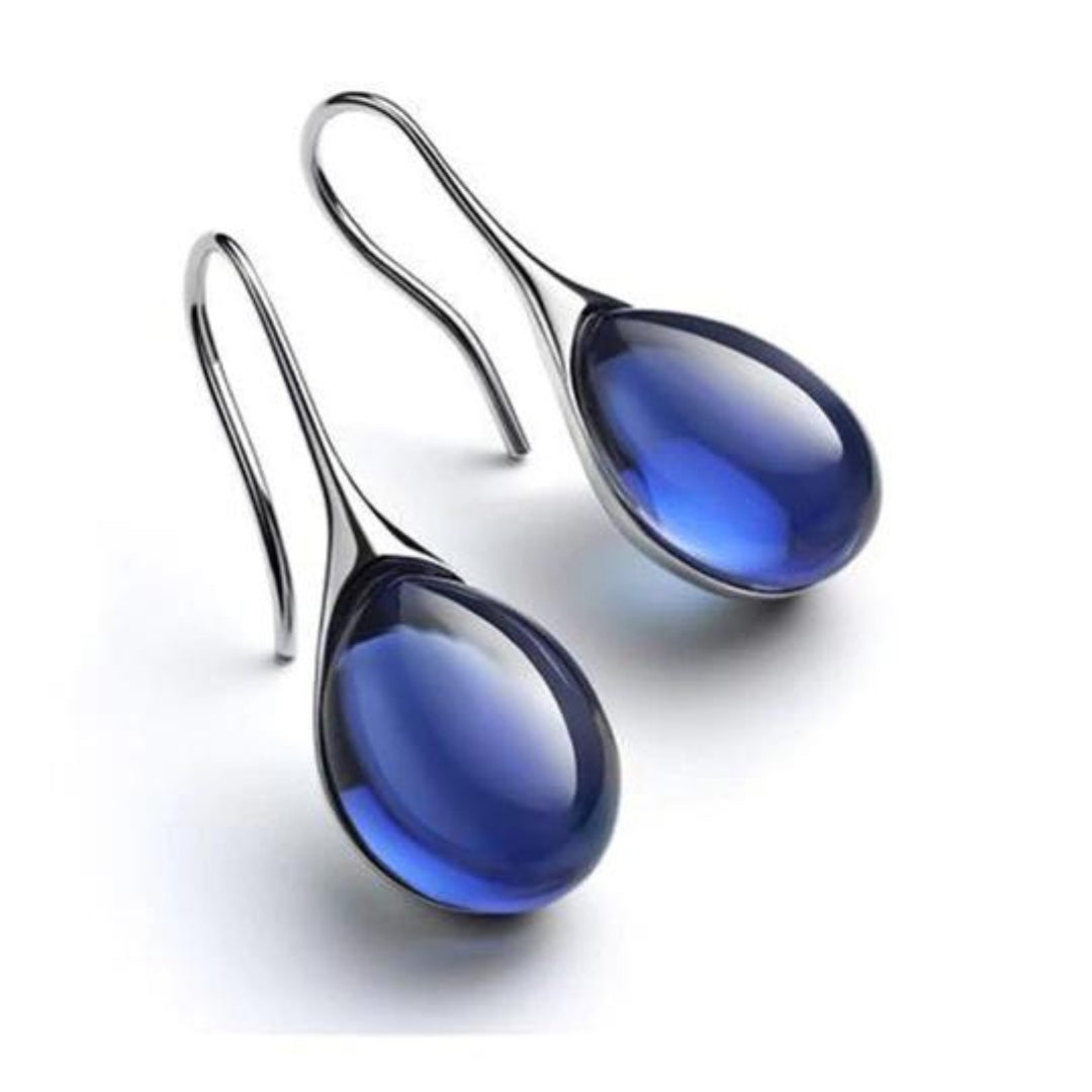 Deep blue teardrop cabochon drop earrings with silver-tone hook wires