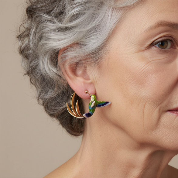 Enamel hummingbird hoop earring worn with short silver hair