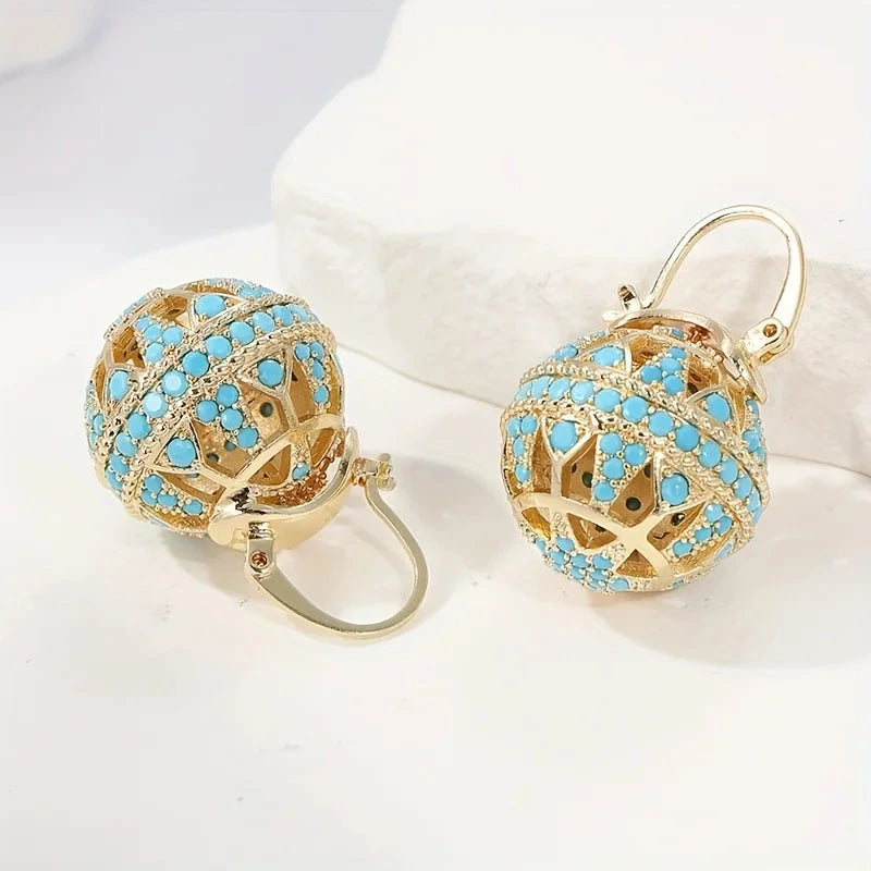 Gold-tone filigree globe drop earrings set with turquoise-effect stones