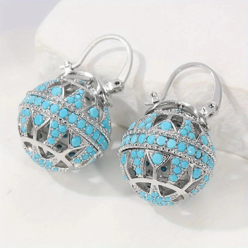 Gold-tone filigree globe drop earrings set with turquoise-effect stones