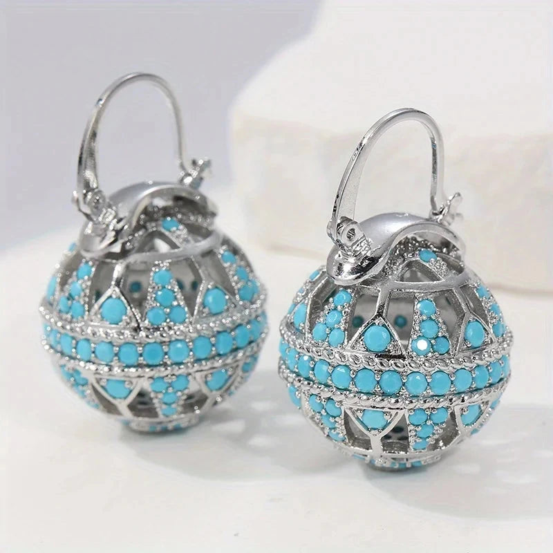 Gold-tone filigree globe drop earrings set with turquoise-effect stones