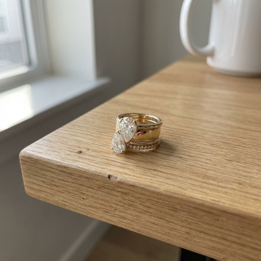 Gold-tone statement ring with two large pear-cut crystals above a pave band