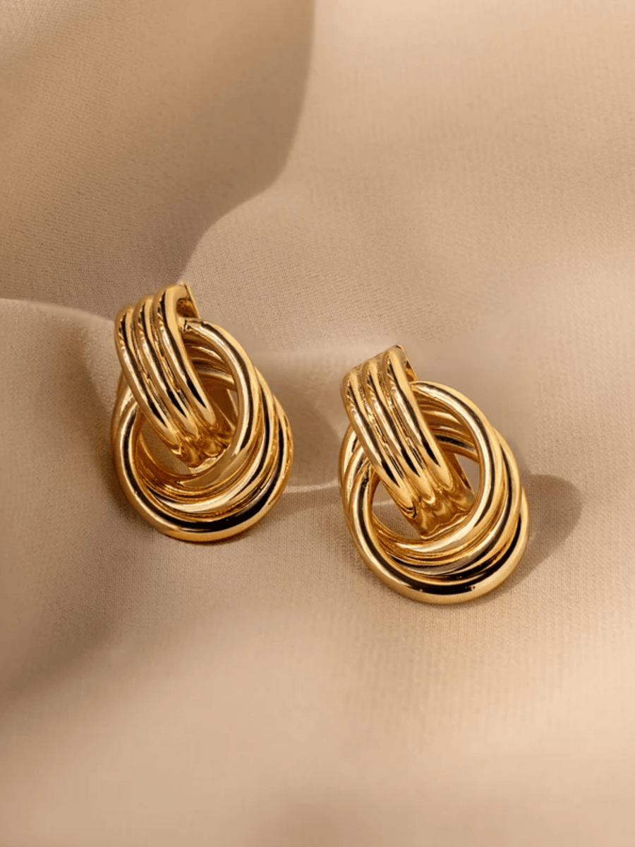 Gold-tone stud earrings shaped as two interlocking hoops through a knot