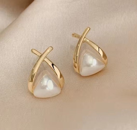 Gold-tone stud earrings with a domed triangular pearl-effect cabochon crossed by two polished bars