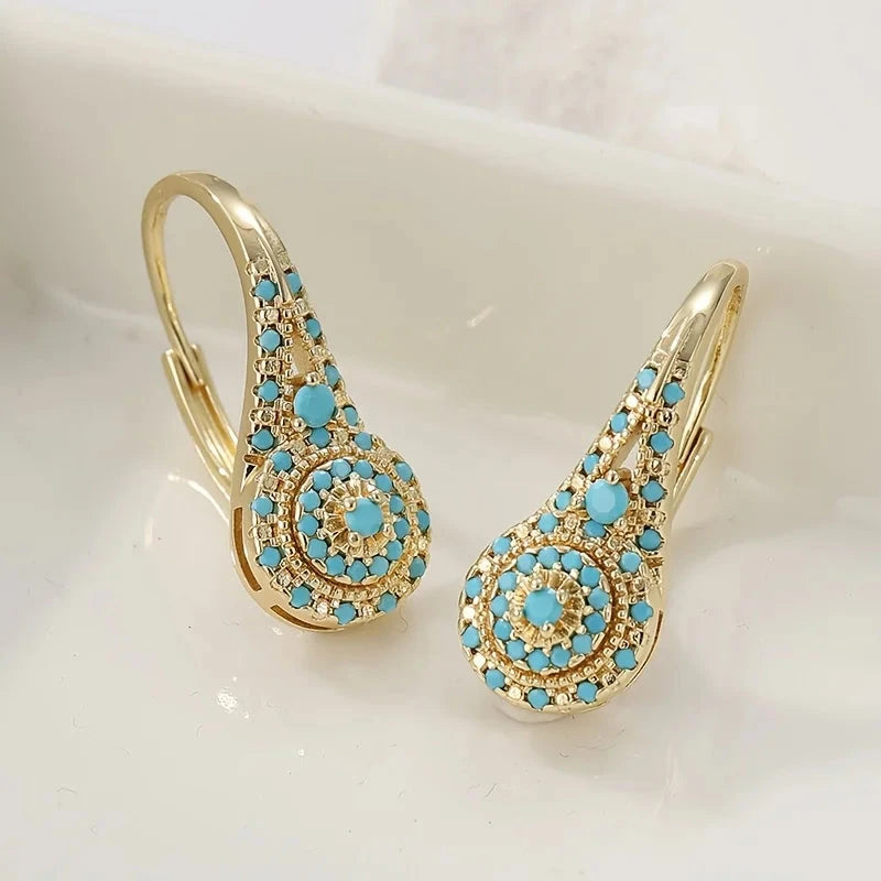 Gold-tone teardrop drop earrings with a turquoise-effect stone mosaic