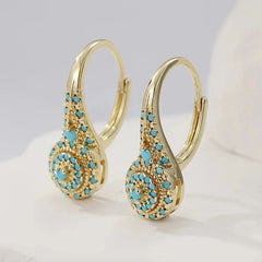Gold-tone teardrop drop earrings with a turquoise-effect stone mosaic