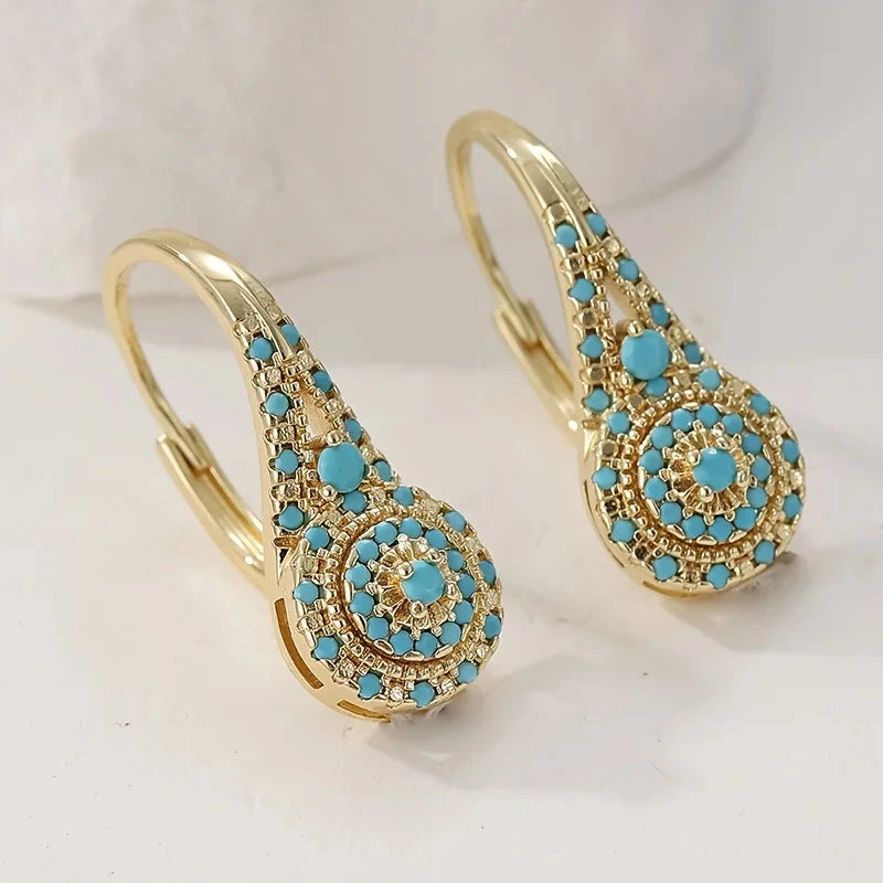 Gold-tone teardrop drop earrings with a turquoise-effect stone mosaic