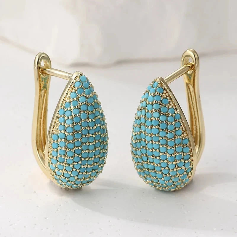 Gold-tone teardrop huggie earrings pave set with turquoise-effect stones