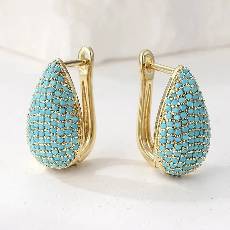 Gold-tone teardrop huggie earrings pave set with turquoise-effect stones