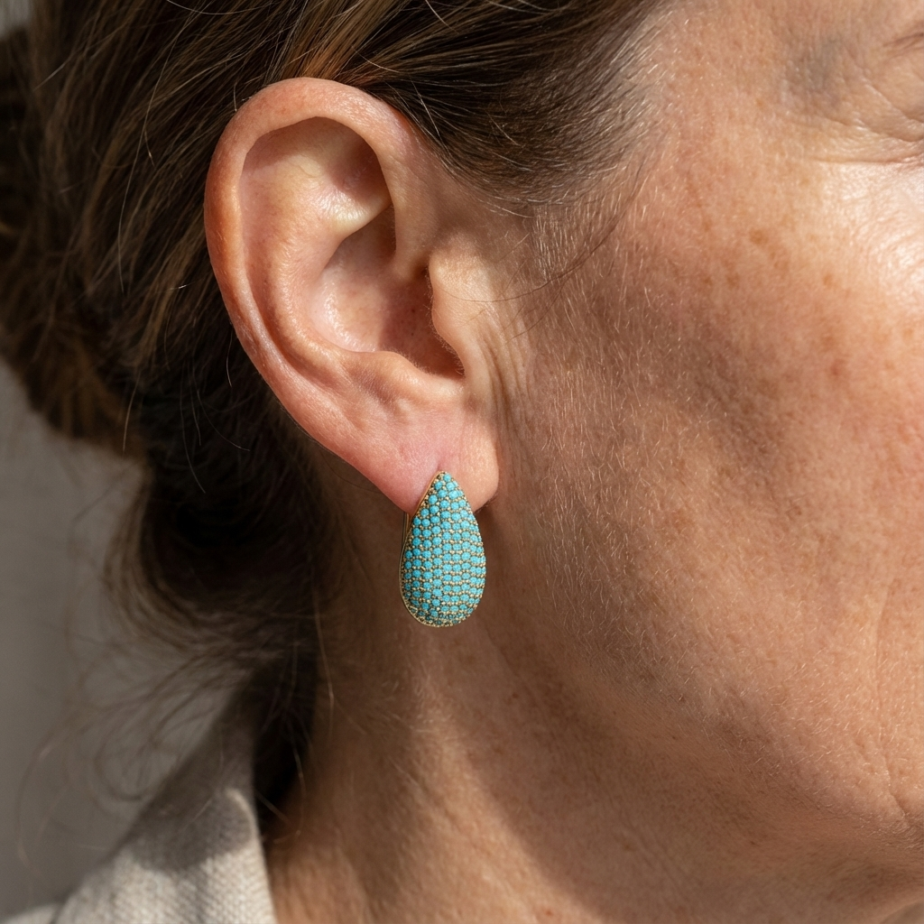 Gold-tone teardrop huggie earrings pave set with turquoise-effect stones