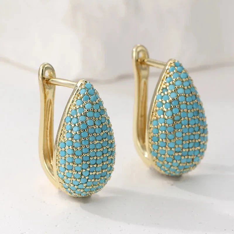 Gold-tone teardrop huggie earrings pave set with turquoise-effect stones