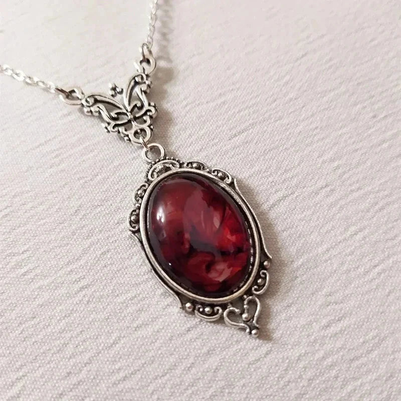 Gothic pendant necklace with a deep red marbled cabochon set in an antiqued silver-tone scrollwork frame