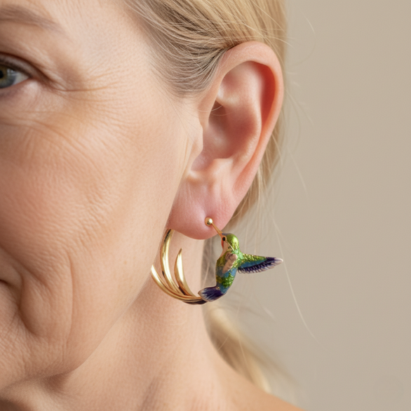 Hummingbird hoop earring seen from the side, showing the three tail feathers