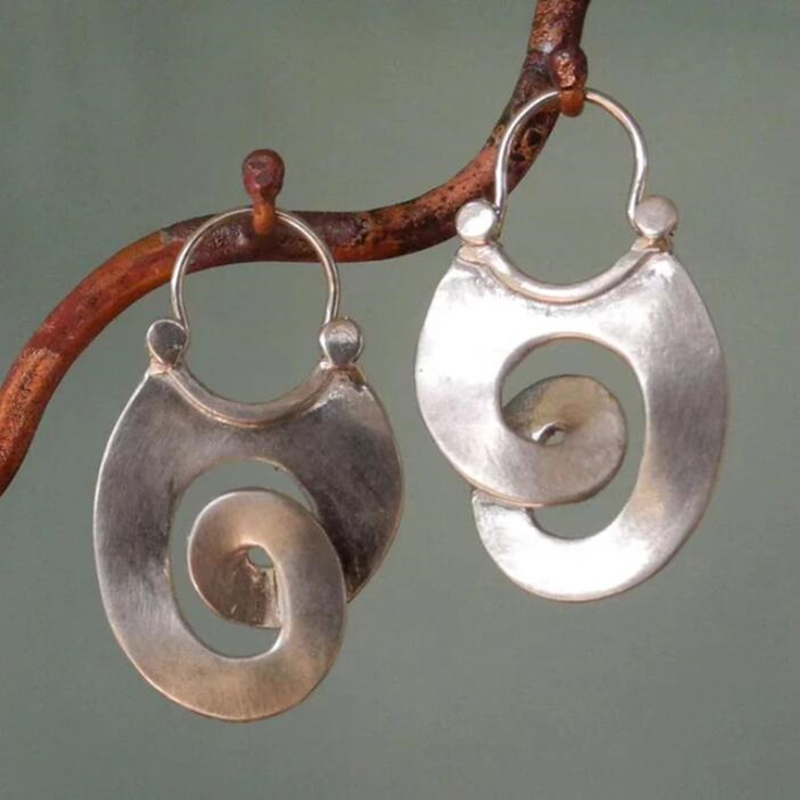 Large brushed silver-tone spiral disc earrings on a dark leather cord