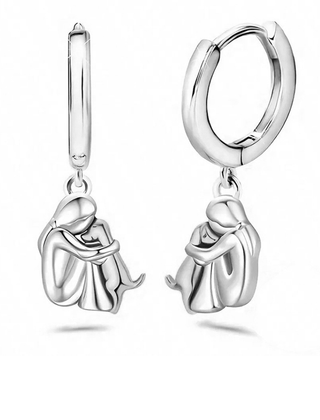 Matching huggie earrings of the same figure and dog in an all silver-tone finish