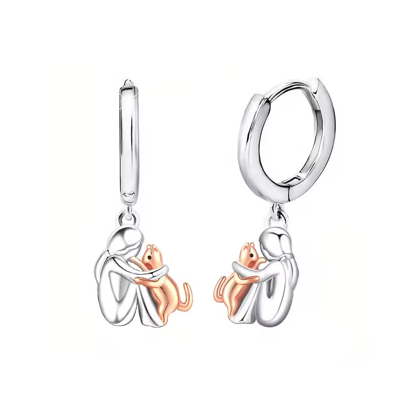 Matching huggie hoop earrings with the same figure and a rose gold-tone cat