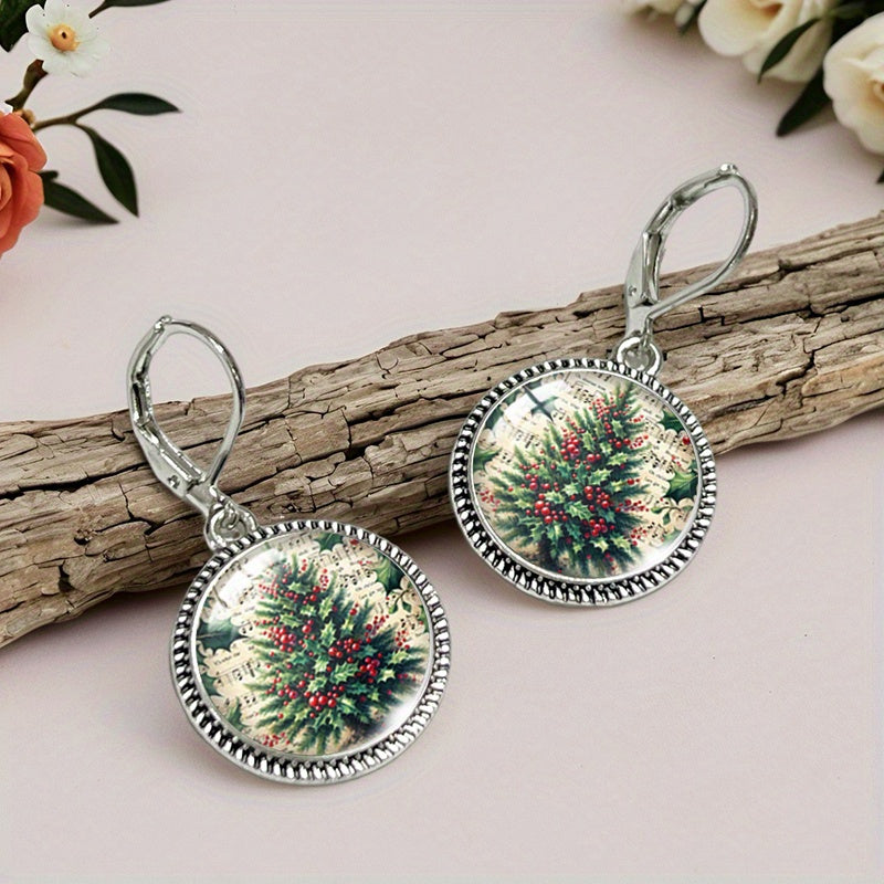 Pair of Christmas tree drop earrings resting on driftwood