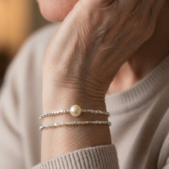 Pair of fine silver-tone beaded bracelets, one with a faux pearl drop