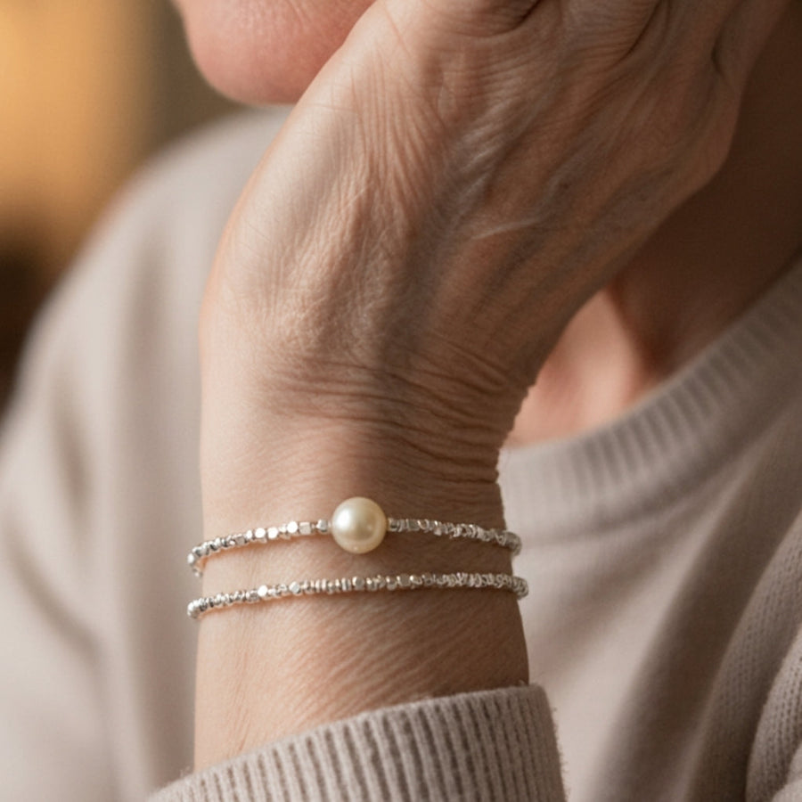 Pair of fine silver-tone beaded bracelets, one with a faux pearl drop