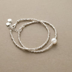 Pair of fine silver-tone beaded bracelets, one with a faux pearl drop