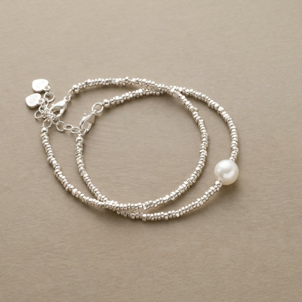 Pair of fine silver-tone beaded bracelets, one with a faux pearl drop