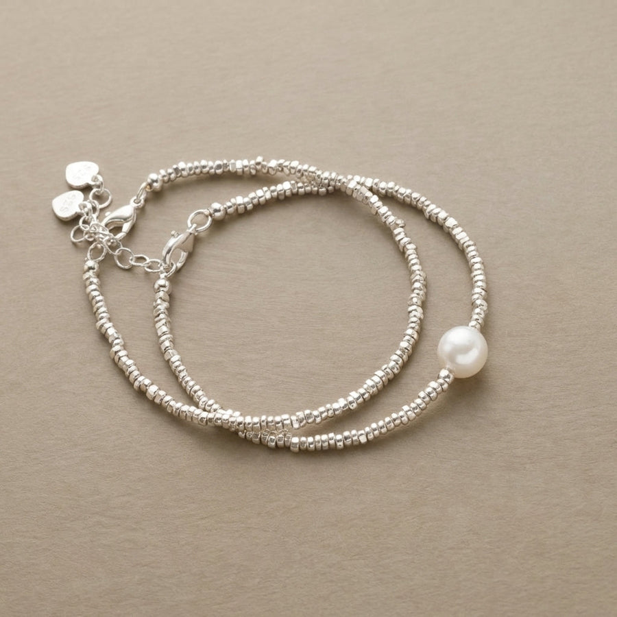 Pair of fine silver-tone beaded bracelets, one with a faux pearl drop