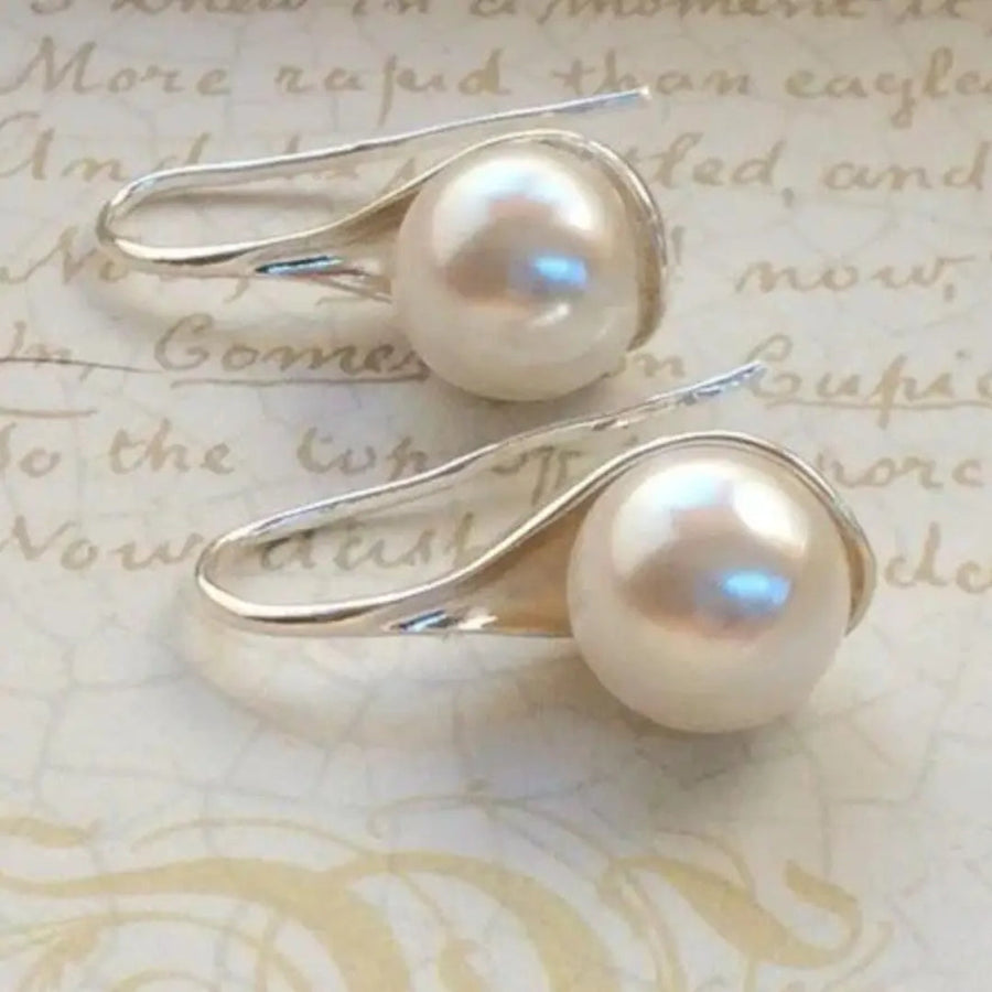 Pair of pearl drop earrings with round cream beads on sculpted silver-tone hooks