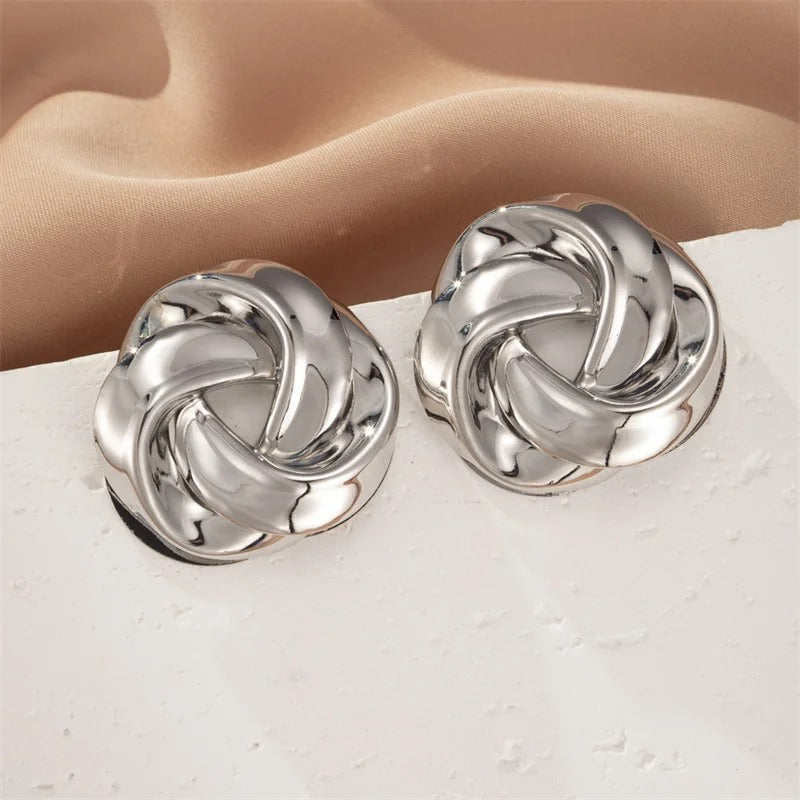 Pair of silver-tone knot stud earrings with interlaced polished bands