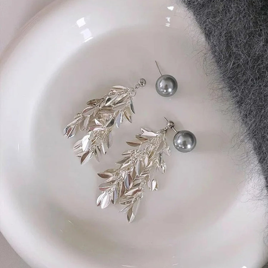 Pair of silver-tone statement earrings with a grey pearl bead and a long cluster of small polished leaves