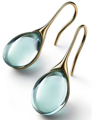 Pale green teardrop cabochon drop earrings in a gold-tone cradle setting