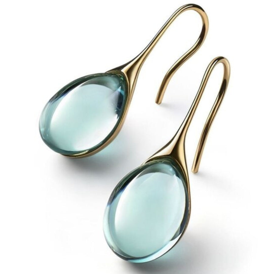 Pale green teardrop cabochon drop earrings in a gold-tone cradle setting