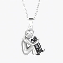 Pendant necklace of a short-haired figure hugging a black-finished dog
