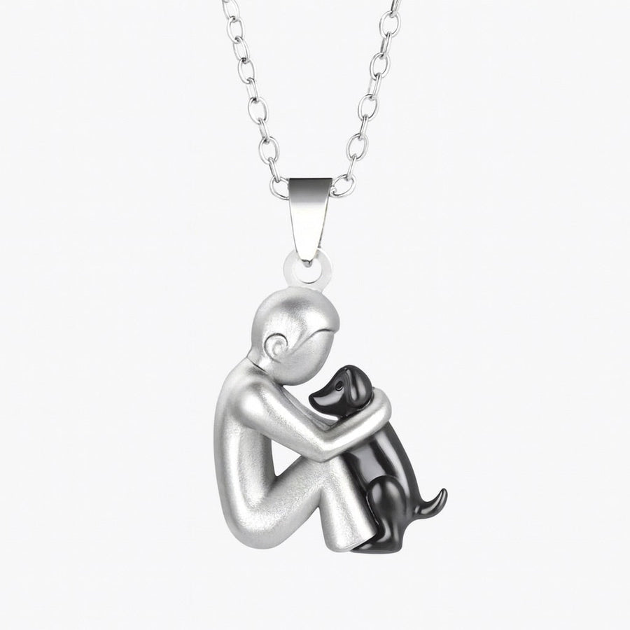 Pendant necklace of a short-haired figure hugging a black-finished dog