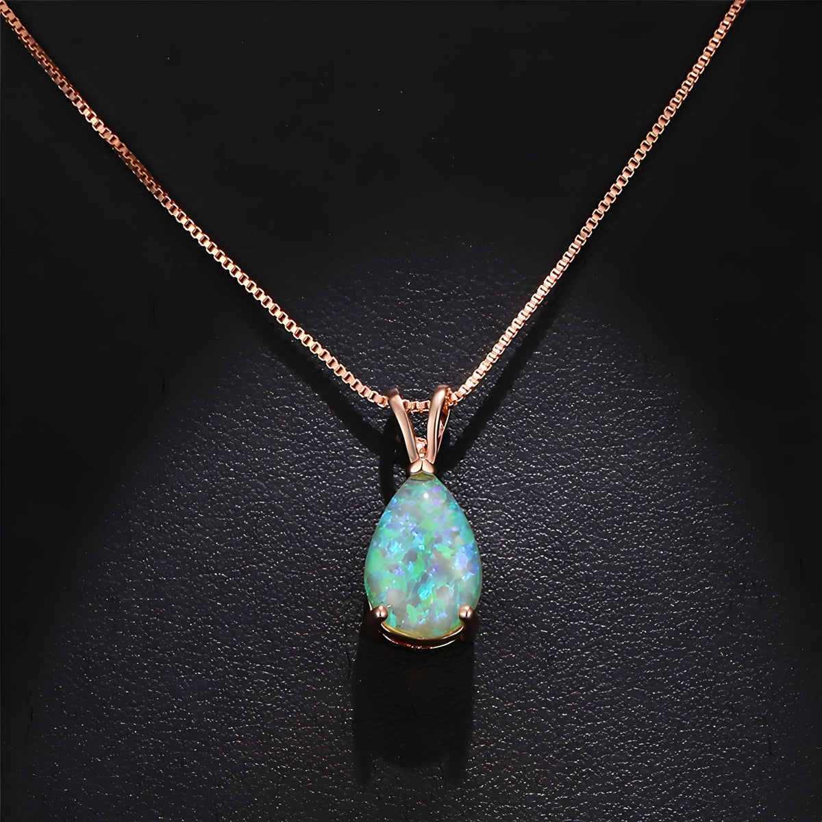 Rose gold-tone opal necklace with a pale sea-green pear-shaped stone in a four-claw setting on a fine box chain