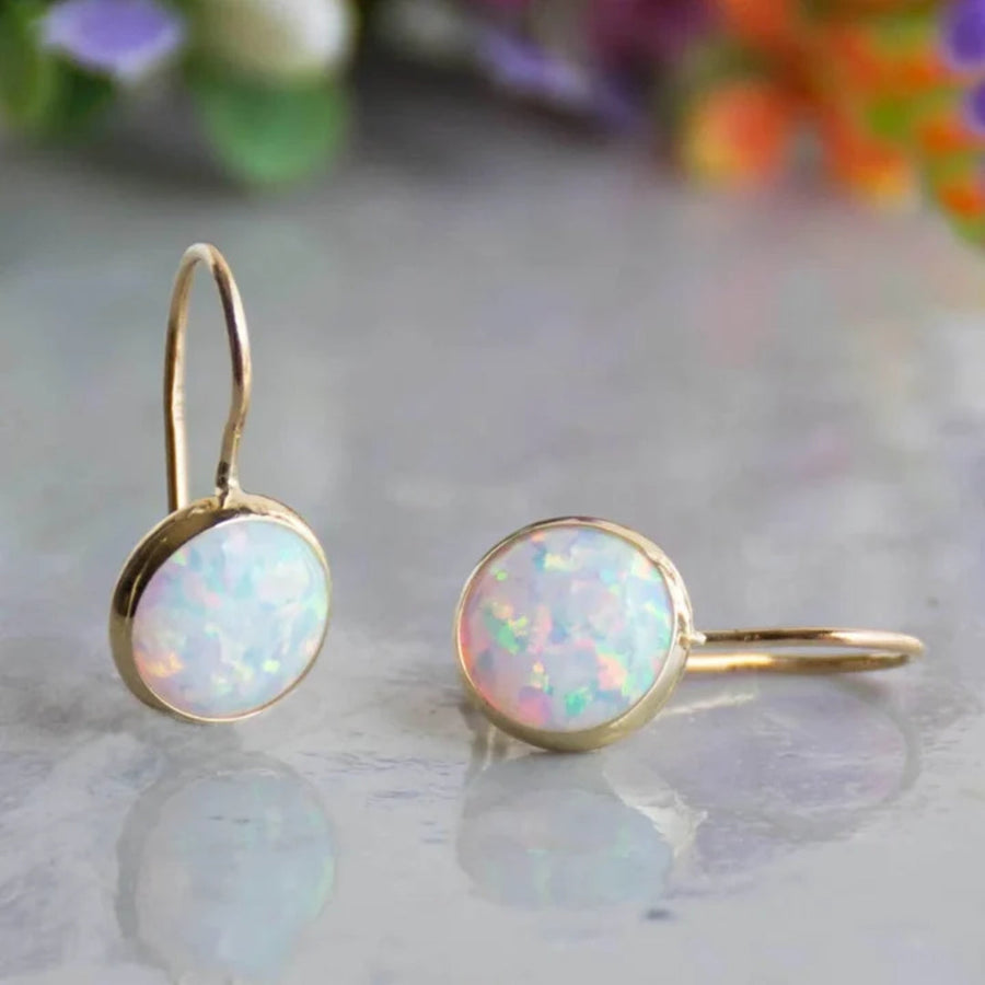 Round white opal drop earrings in plain gold-tone bezels with fixed hook ear wires