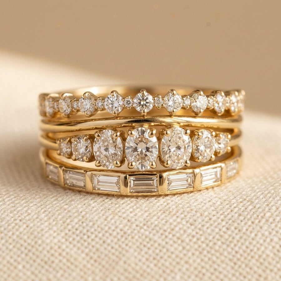 Set of four gold-tone stacking rings with clear crystal settings