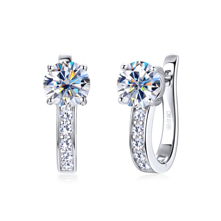 Silver-tone huggie hoop earrings with a claw-set clear stone and a hinged snap closure