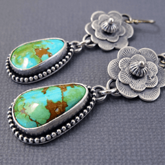 Silver-tone rose drop earrings with a large veined turquoise-effect teardrop