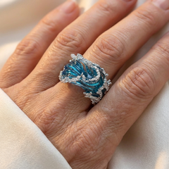 Silver-tone statement ring shaped as a breaking wave with blue enamel