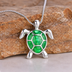 Silver-tone turtle pendant necklace with a green opal shell