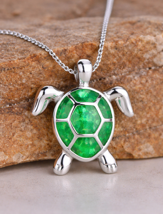 Silver-tone turtle pendant necklace with a green opal shell