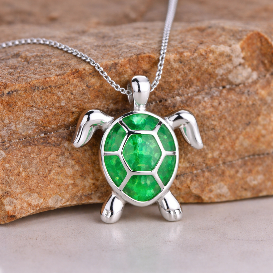 Silver-tone turtle pendant necklace with a green opal shell