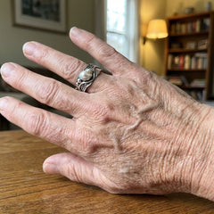 Silver-tone wave ring holding an irregular baroque faux pearl