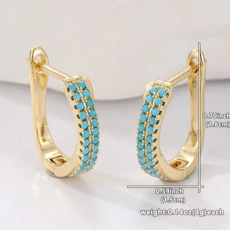 Slim gold-tone huggie hoop earrings with two rows of turquoise-effect pave