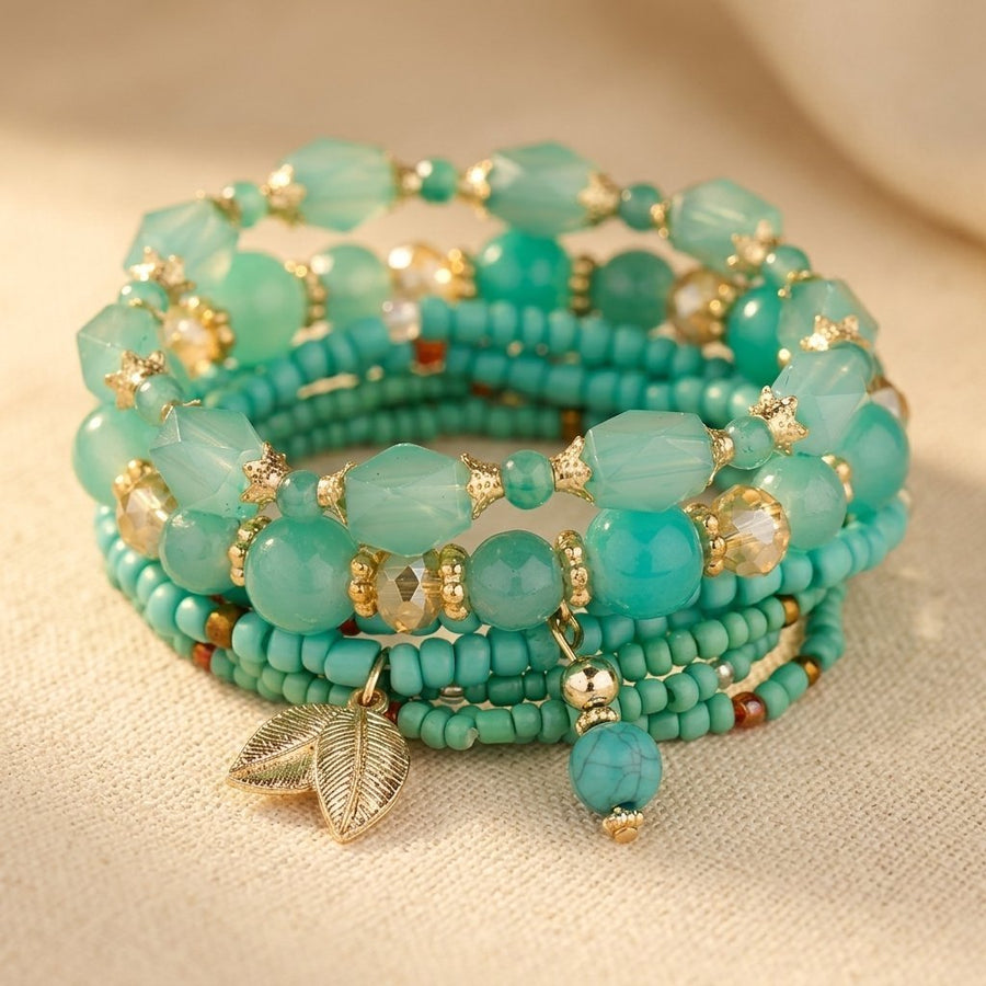 Stack of four turquoise and green beaded stretch bracelets