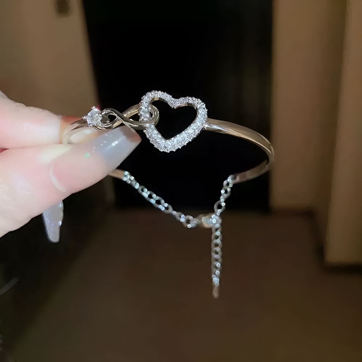 The same bangle in white gold tone, showing the extension chain at the back