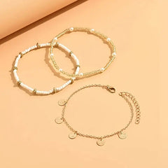 The three anklets at an angle, showing the lobster clasp and extender chain