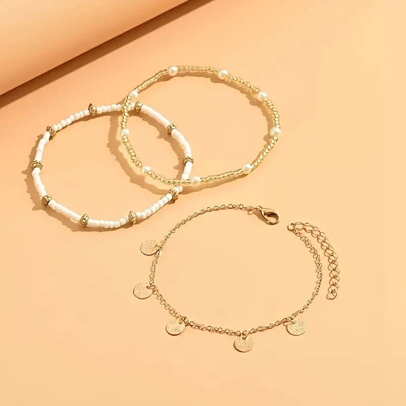 The three anklets at an angle, showing the lobster clasp and extender chain